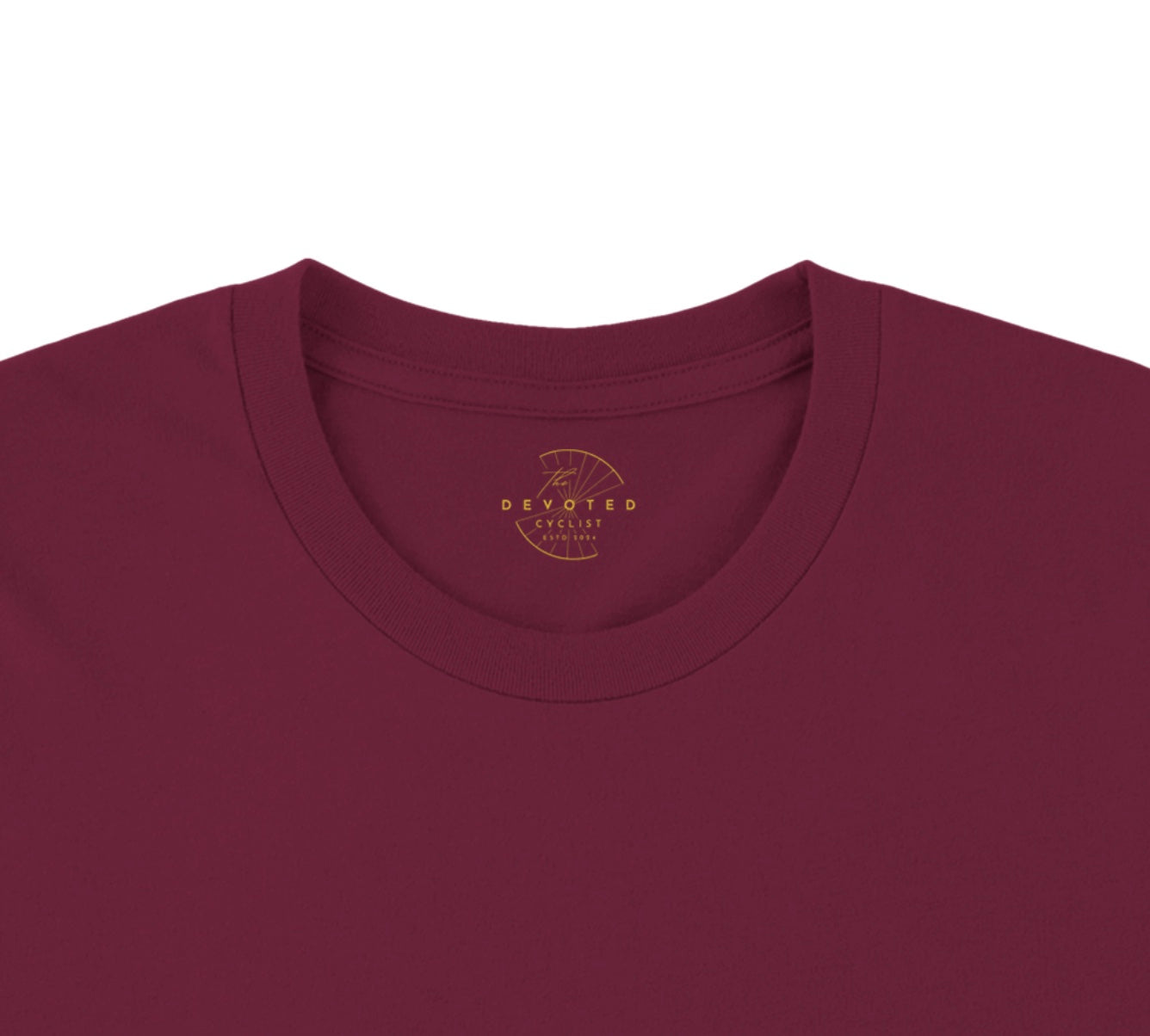 The close up image of a marron T-shirt on 
 a white background from The Devoted Cyclist to show the printed logo, here in gold, on the inner neck